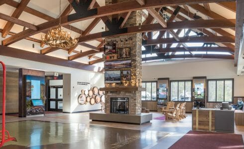 Interior of the Adirondack Welcome Center in Queensbury, NY featuring Douglas fir Glulam Heavy Timber Trusses with steel plates.