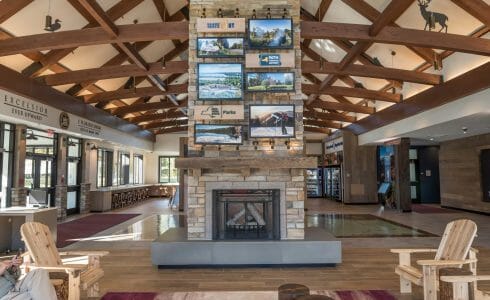 Interior of the Adirondack Welcome Center in Queensbury, NY featuring Douglas fir Glulam Heavy Timber Trusses with steel plates.