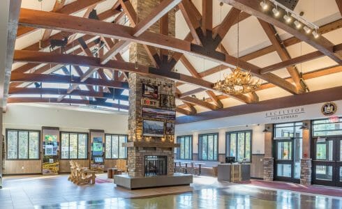 Interior of the Adirondack Welcome Center in Queensbury, NY featuring Douglas fir Glulam Heavy Timber Trusses with steel plates.