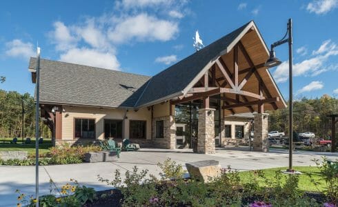 Exterior of the Adirondack Welcome Center in Queensbury, NY featuring Douglas fir Glulam Heavy Timber Trusses with steel plates.