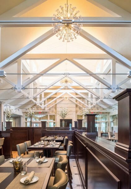 Modern, White heavy timber trusses with steel plates and tie bars in the Anya Restaurant in Thompson, CT.