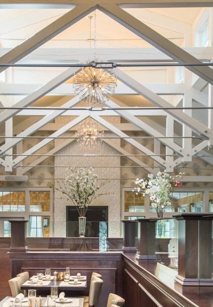 Modern, White heavy timber trusses with steel plates and tie bars in the Anya Restaurant in Thompson, CT.