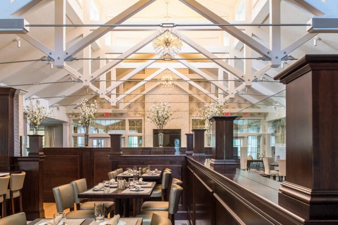 Modern, White heavy timber trusses with steel plates and tie bars in the Anya Restaurant in Thompson, CT.