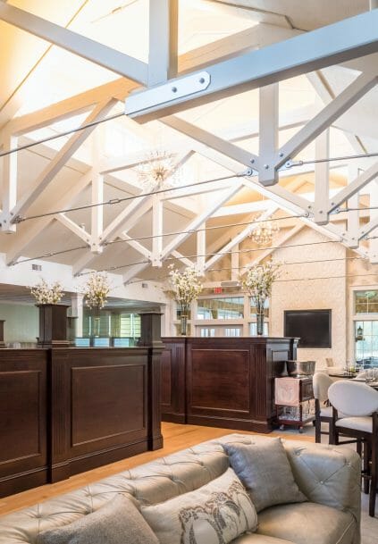 Modern, White heavy timber trusses with steel plates and tie bars in the Anya Restaurant in Thompson, CT.