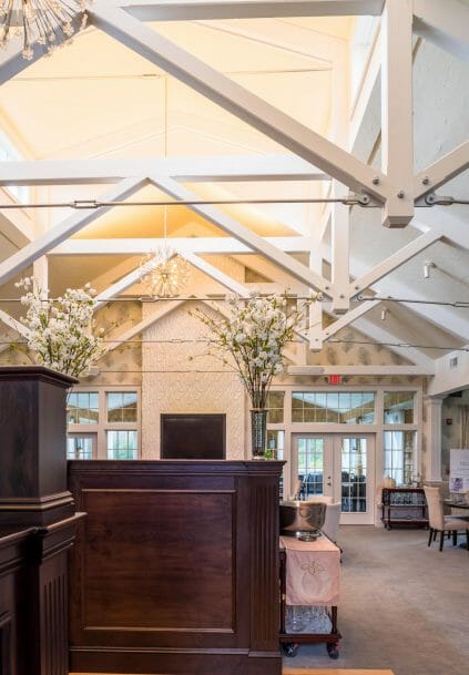 Modern, White heavy timber trusses with steel plates and tie bars in the Anya Restaurant in Thompson, CT.