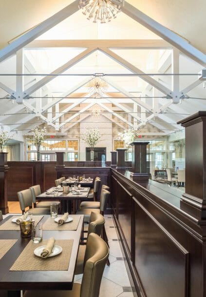 Modern, White heavy timber trusses with steel plates and tie bars in the Anya Restaurant in Thompson, CT.