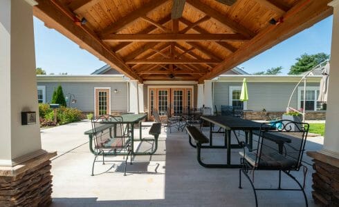 Heavy Timber Walkway with King Post Trusses in Doug fir, planed and chamfered with post bases with stone in Voorhees, NJ