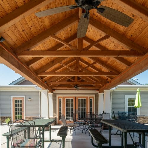 Heavy Timber Walkway with King Post Trusses in Doug fir, planed and chamfered with post bases with stone in Voorhees, NJ