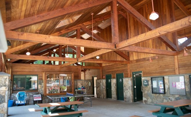 Interior of the Katonah Pool house made with a heavy timber frame and trusses with stone post bases in Katonah New York.