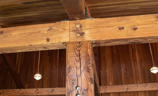 Interior of the Katonah Pool house made with a heavy timber frame and trusses with stone post bases in Katonah New York.