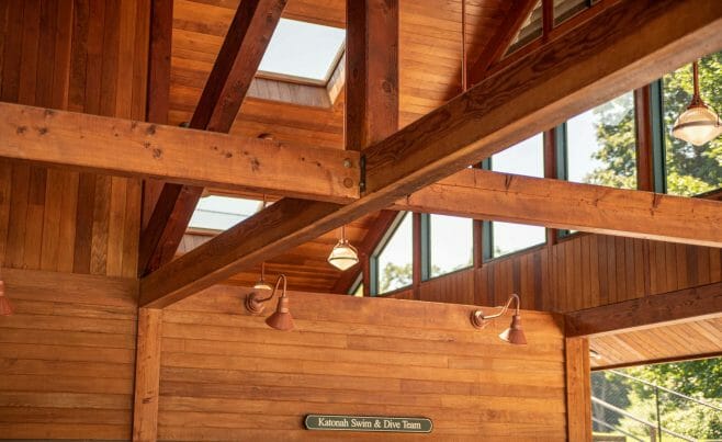 Interior of the Katonah Pool house made with a heavy timber frame and trusses with stone post bases in Katonah New York.