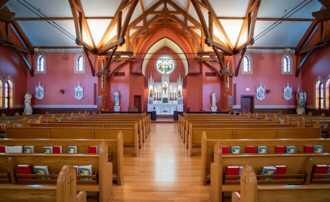 The completed interior of St. Michael's Church with arched trusses and steel tie rods