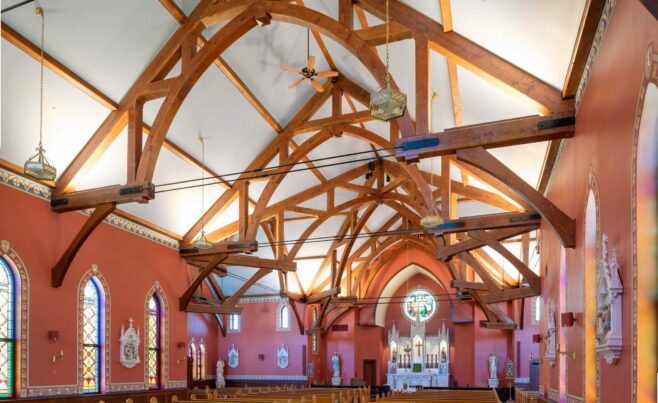 The completed interior of St. Michael's Church with arched trusses and steel tie rods