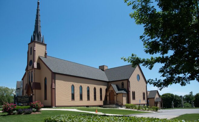 The completed interior of St. Michael's Church with arched trusses and steel tie rods