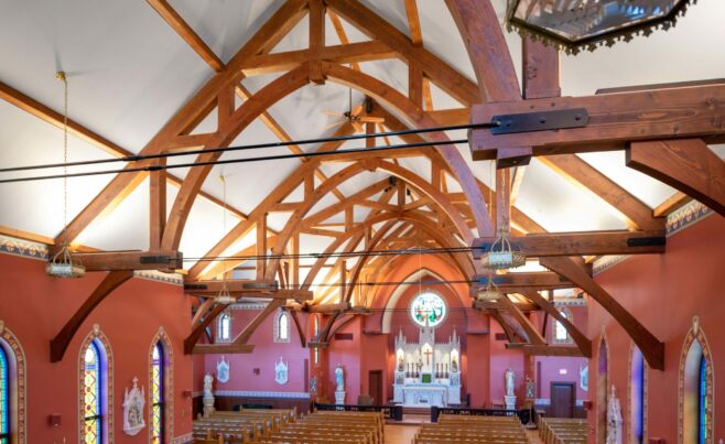 The completed interior of St. Michael's Church with arched trusses and steel tie rods