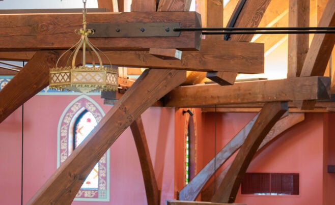 The completed interior of St. Michael's Church with arched trusses and steel tie rods