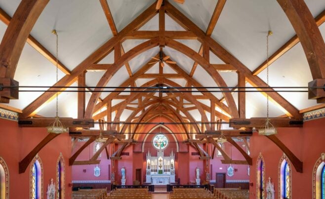 The completed interior of St. Michael's Church with arched trusses and steel tie rods
