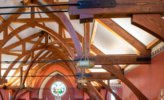 The completed interior of St. Michael's Church with arched trusses and steel tie rods