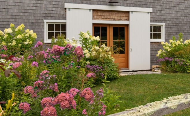 Exterior of a Guest Cottage Beach House in Martha's Vineyard overlooking the pool with traditional weathered Cedar siding