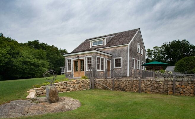 Exterior of a Guest Cottage Beach House in Martha's Vineyard overlooking the pool with traditional weathered Cedar siding