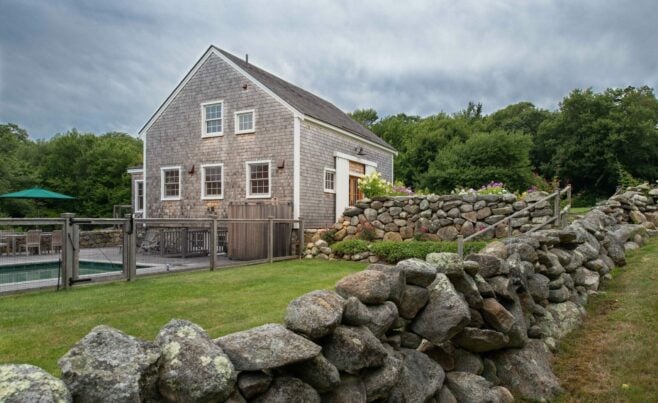 Exterior of a Guest Cottage Beach House in Martha's Vineyard overlooking the pool with traditional weathered Cedar siding