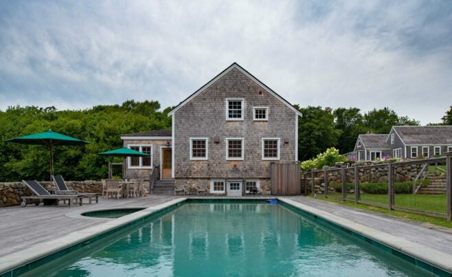 Exterior of a Guest Cottage Beach House in Martha's Vineyard overlooking the pool with traditional weathered Cedar siding