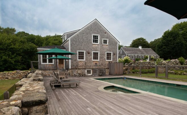 Exterior of a Guest Cottage Beach House in Martha's Vineyard overlooking the pool with traditional weathered Cedar siding