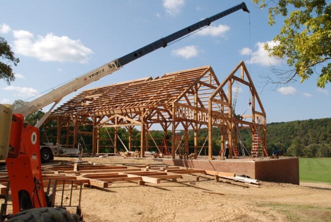 A Timber Frame being raised with a crane.