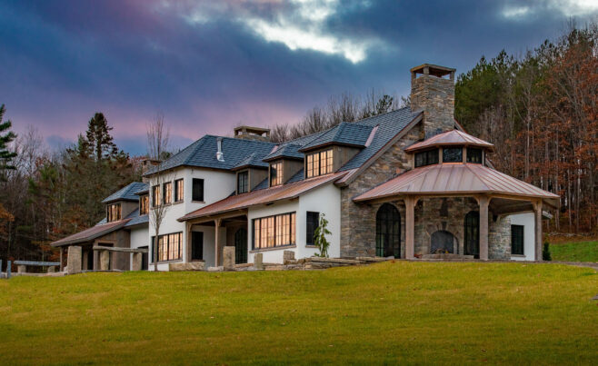 Exterior of a home in New Hampshire with a Hand Hewn Timber Framed Loggia or attached outdoor entertainment area