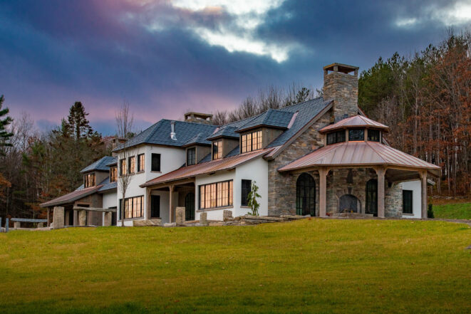 Exterior of a home in New Hampshire with a Hand Hewn Timber Framed Loggia or attached outdoor entertainment area