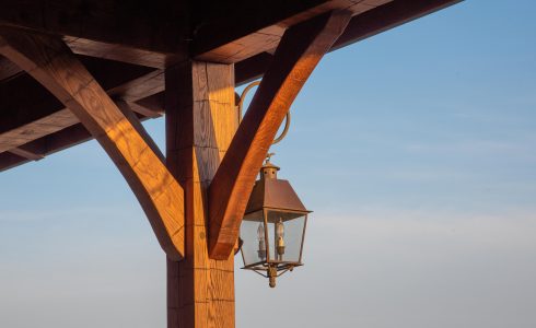 Hand hewn oak timber frame detail with a pretty electric lantern.