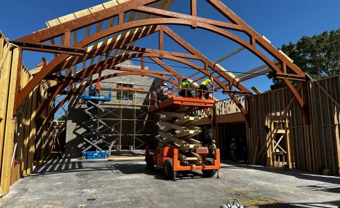 Installation of heavy timber arched trusses.