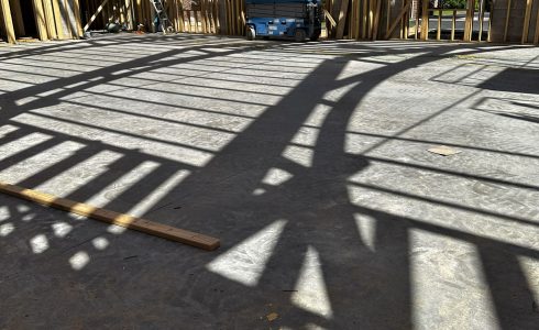 Shadows of a heavy timber arched truss.