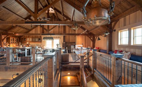 Timber framed barn upstairs featuring king post trusses