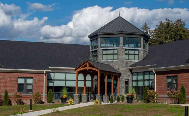 Arched timber truss canopy on a school entryway