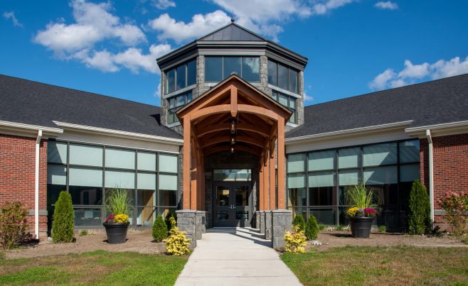 Front view of an arched timber truss entryway