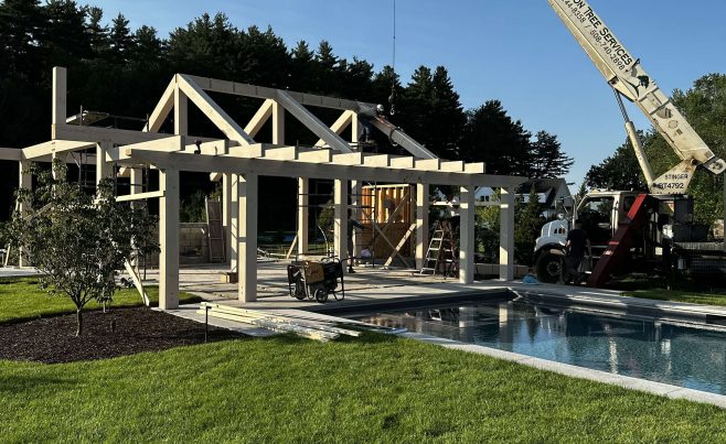 Pool house installation with a crane.