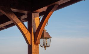 Curved hand hewn oak braces with a pretty lantern.
