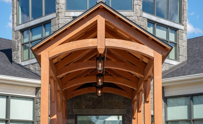 Arched timber truss with hidden steel tie plates